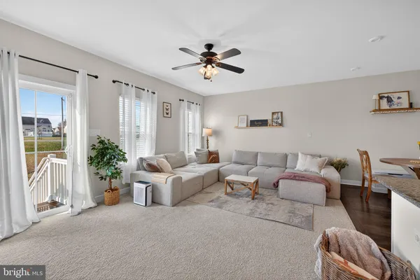 a living room with patio furniture and a chandelier