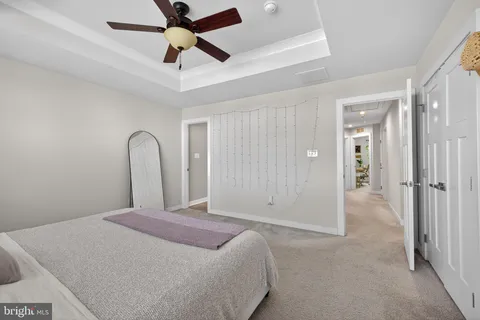 a bathroom with a granite countertop double vanity sink a shower and a mirror
