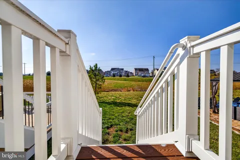 a view of a house with backyard porch and sitting area