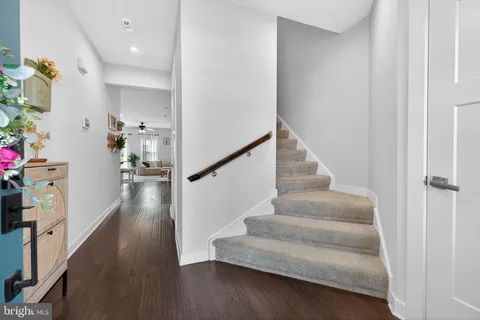 a view of entryway and hall with wooden floor