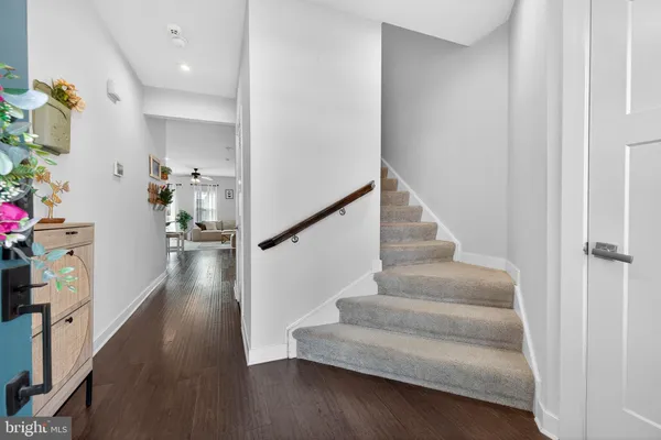 a view of entryway and hall with wooden floor
