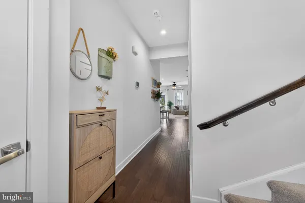 a view of a hallway with wooden floor and entryway