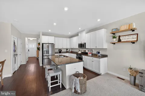 a kitchen with a sink appliances and cabinets