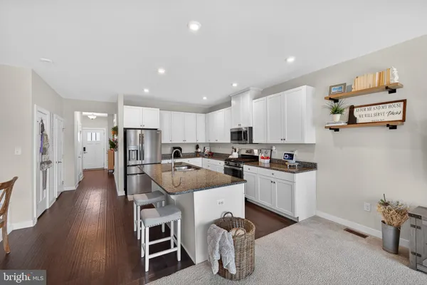 a kitchen with a sink appliances and cabinets