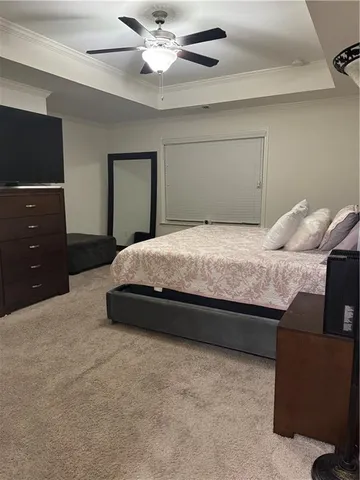 a bedroom with a bed and a ceiling fan