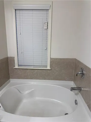 a white bath tub sitting in a bathroom