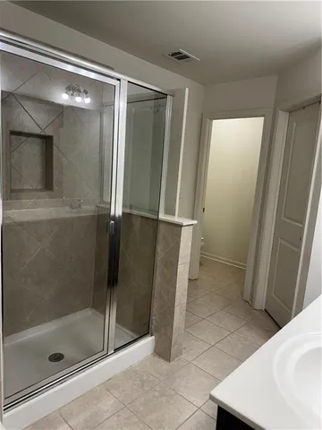 a bathroom with a shower and a sink