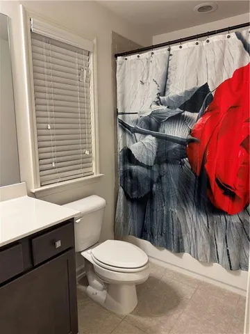 a bathroom with a toilet a sink and a window