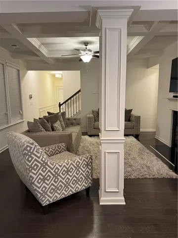 a living room with furniture and a chandelier