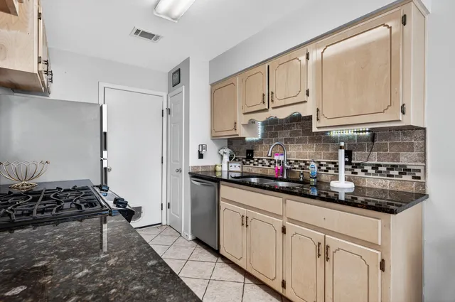 a kitchen with stainless steel appliances granite countertop a stove and a refrigerator