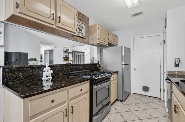 a kitchen with sink cabinets and stove top oven