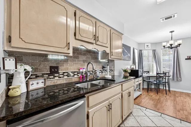 a kitchen with stainless steel appliances granite countertop a stove and cabinets