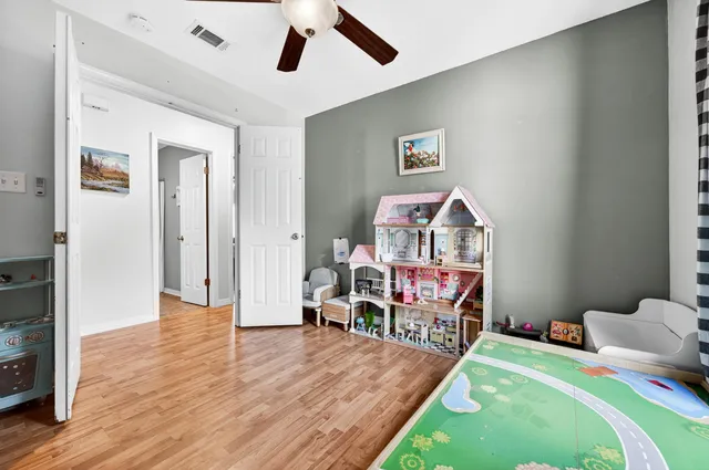 a bathroom with a granite countertop sink toilet and mirror