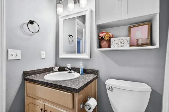 a bedroom with a bed and a flat tv screen on dresser