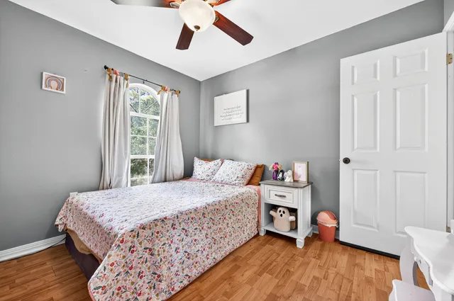a bedroom with a bed and wooden floor