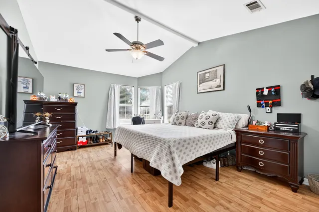 a bedroom with a bed and flat screen tv