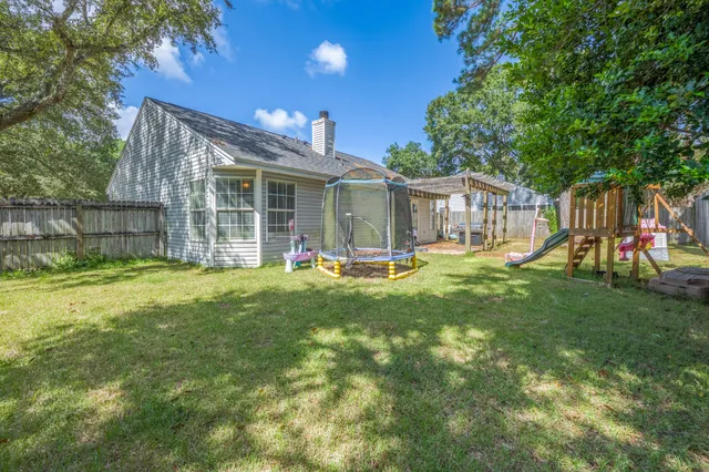 a view of a porch with furniture and a backyard