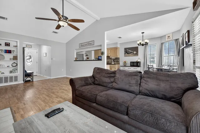 a living room with furniture and a chandelier