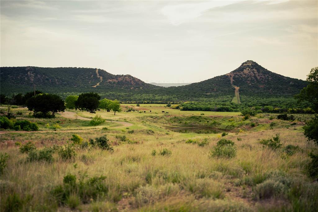 View of mountain backdrop with rural landscape