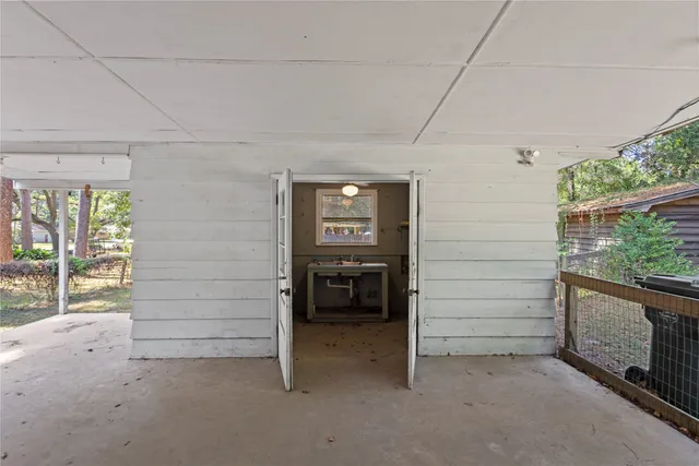 a view of a house with porch and garden
