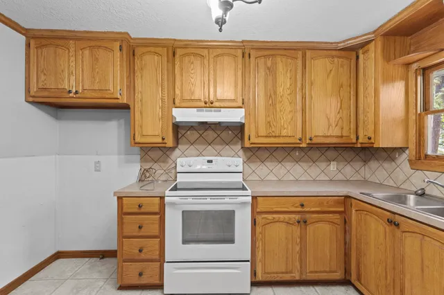 a kitchen with granite countertop cabinets stainless steel appliances and a sink