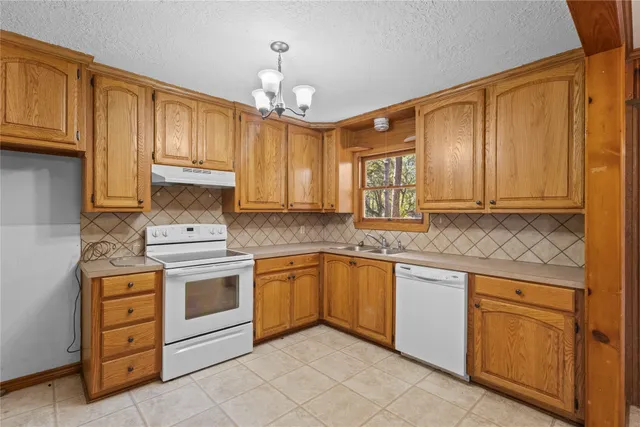 a kitchen with granite countertop cabinets stainless steel appliances and a counter space