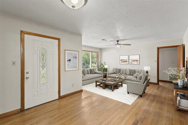 a living room with furniture window and wooden floor
