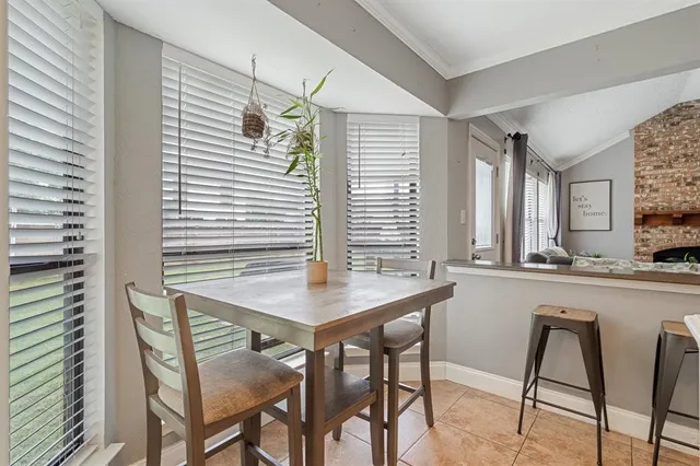 a living room with furniture a fireplace and a potted plant