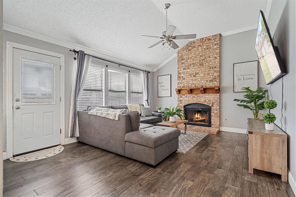 303 Hopewell Street Grand Prairie, TX 75052 - Photo 13 of 28 a living room with furniture a fireplace and a potted plant