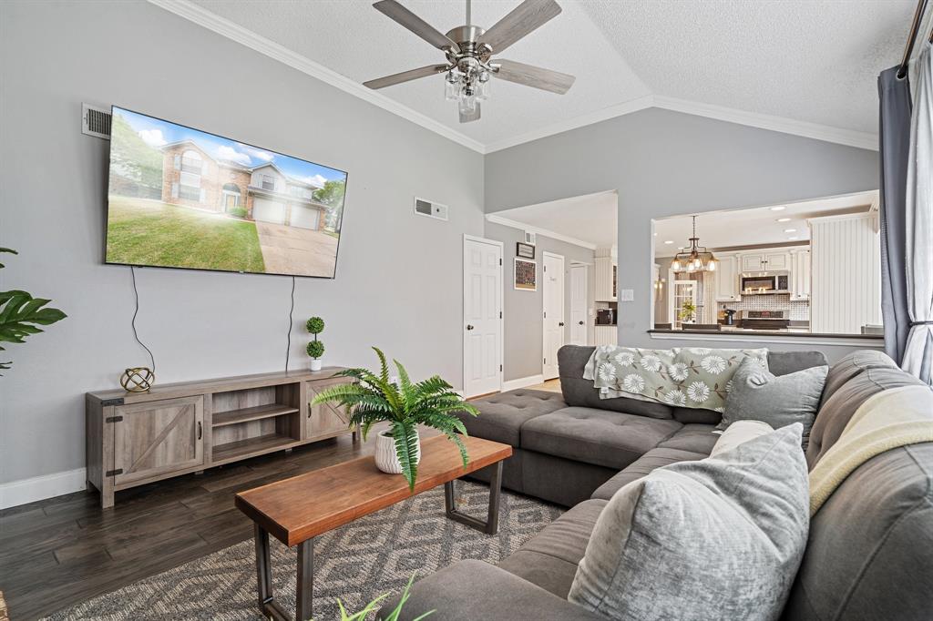 303 Hopewell Street Grand Prairie, TX 75052 - Photo 14 of 28 a living room with furniture or couch and a flat screen tv