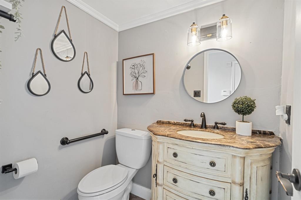 303 Hopewell Street Grand Prairie, TX 75052 - Photo 15 of 28 a bathroom with a granite countertop toilet sink and mirror