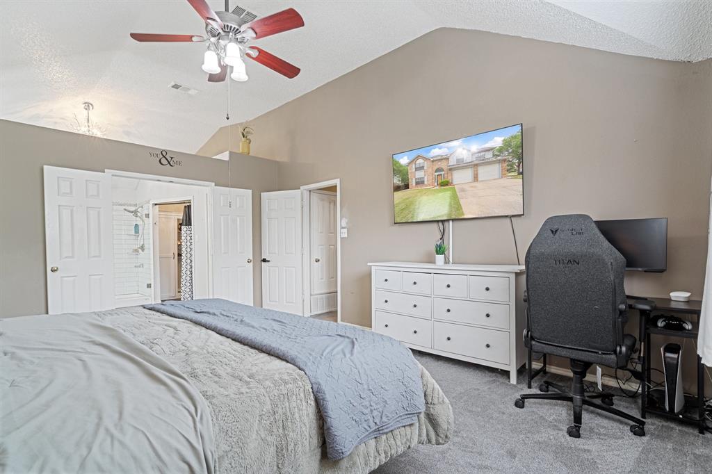 303 Hopewell Street Grand Prairie, TX 75052 - Photo 17 of 28 a bedroom with a baby bed and a chandelier
