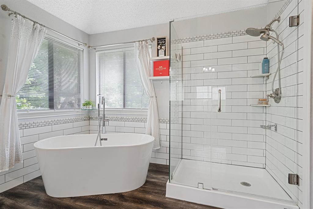 303 Hopewell Street Grand Prairie, TX 75052 - Photo 19 of 28 a white bath tub sitting next to a shower