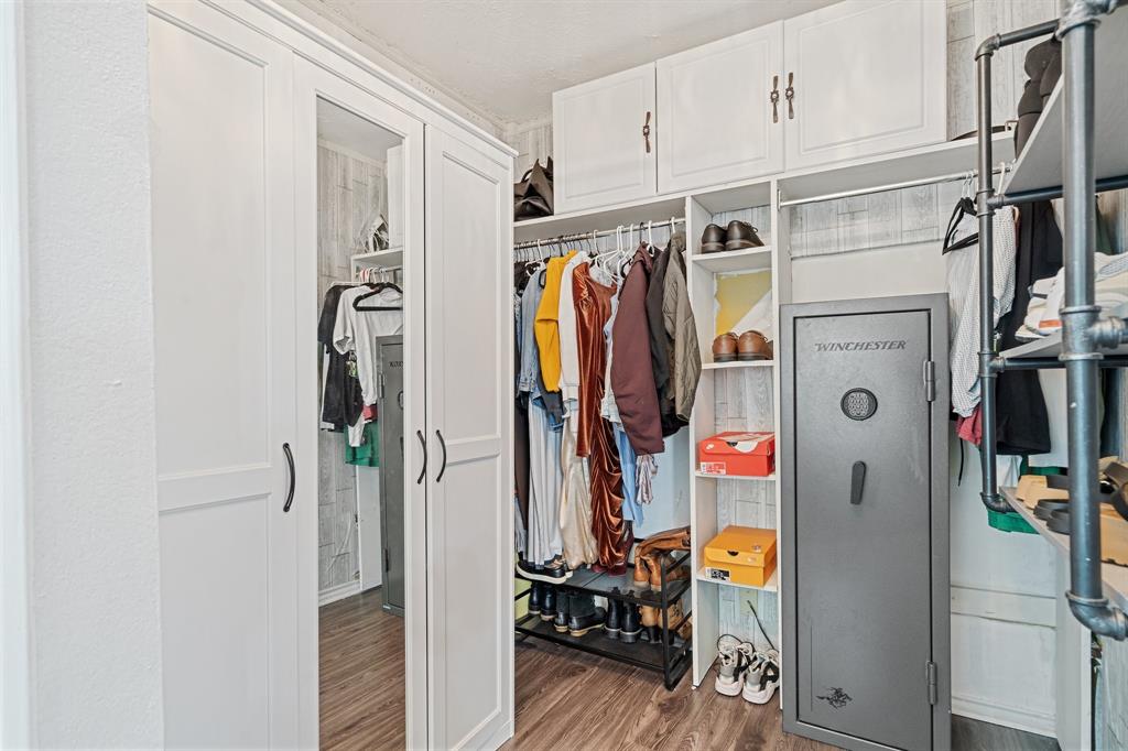 303 Hopewell Street Grand Prairie, TX 75052 - Photo 20 of 28 a view of walk in closet with clothes and shoes