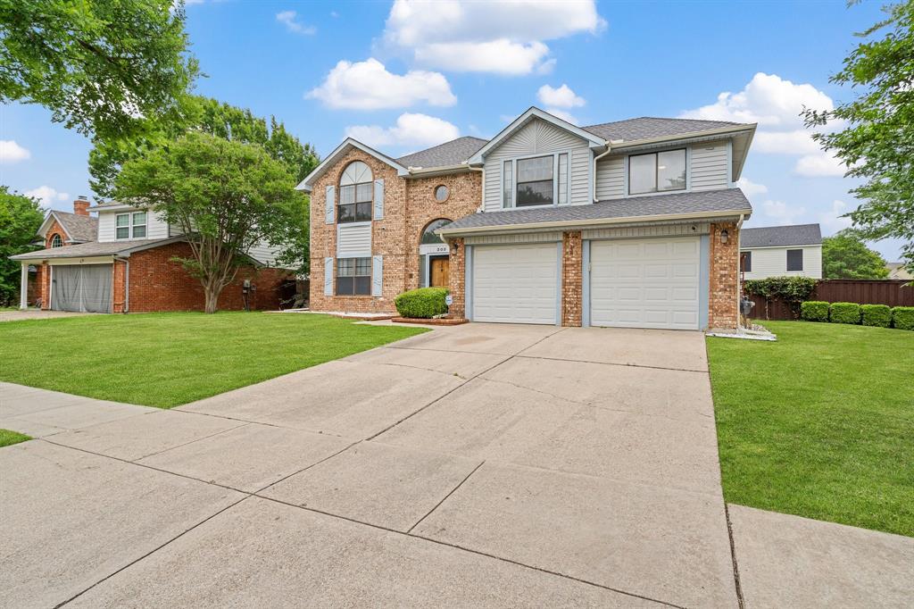 303 Hopewell Street Grand Prairie, TX 75052 - Photo 2 of 28 a front view of a house with a yard and garage