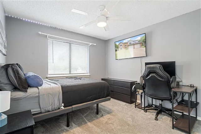 a bathroom with a granite countertop sink a toilet and a mirror