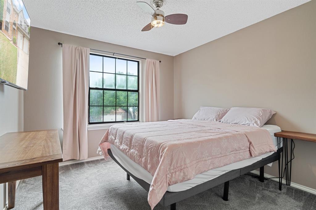 303 Hopewell Street Grand Prairie, TX 75052 - Photo 23 of 28 a bedroom with a bed and a window