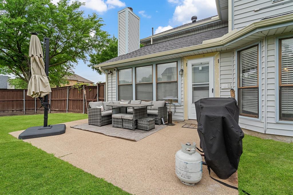 303 Hopewell Street Grand Prairie, TX 75052 - Photo 25 of 28 a view of a house with backyard sitting area and garden