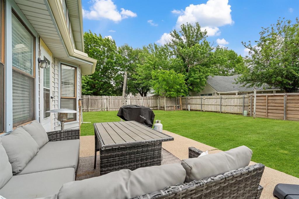 303 Hopewell Street Grand Prairie, TX 75052 - Photo 26 of 28 a view of a patio with couches chairs and a yard