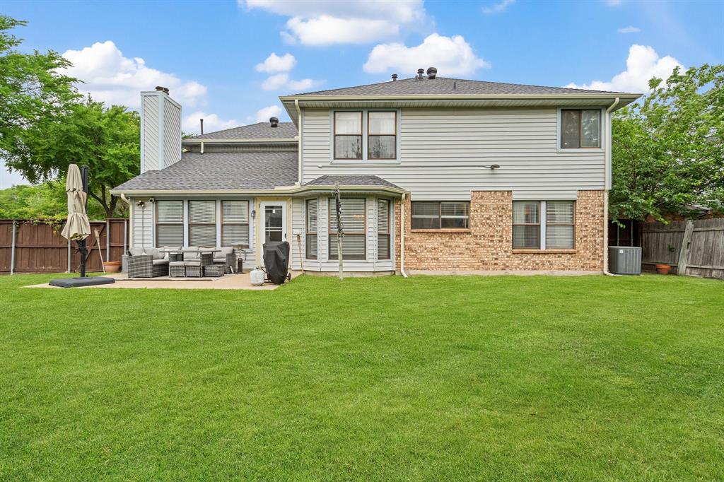 303 Hopewell Street Grand Prairie, TX 75052 - Photo 28 of 28 a front view of a house with a garden