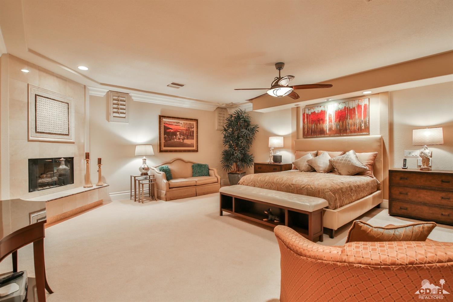 70689 Boothill Road Rancho Mirage, CA 92270 - Photo 21 of 45 a spacious bedroom with a bed and ceiling fan