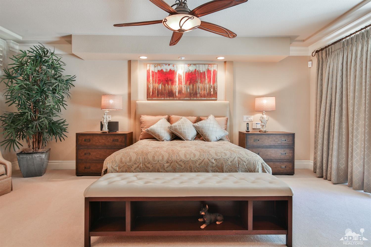70689 Boothill Road Rancho Mirage, CA 92270 - Photo 22 of 45 a bedroom with a bed a couch and potted plant