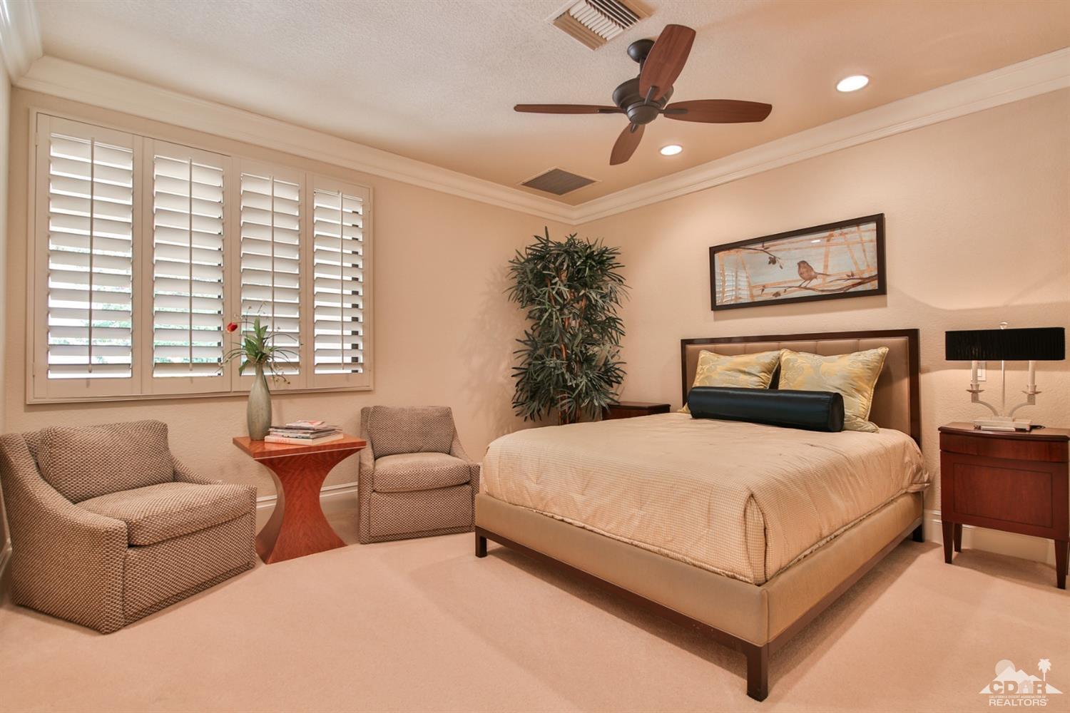70689 Boothill Road Rancho Mirage, CA 92270 - Photo 27 of 45 a bedroom with a large bed couch and window