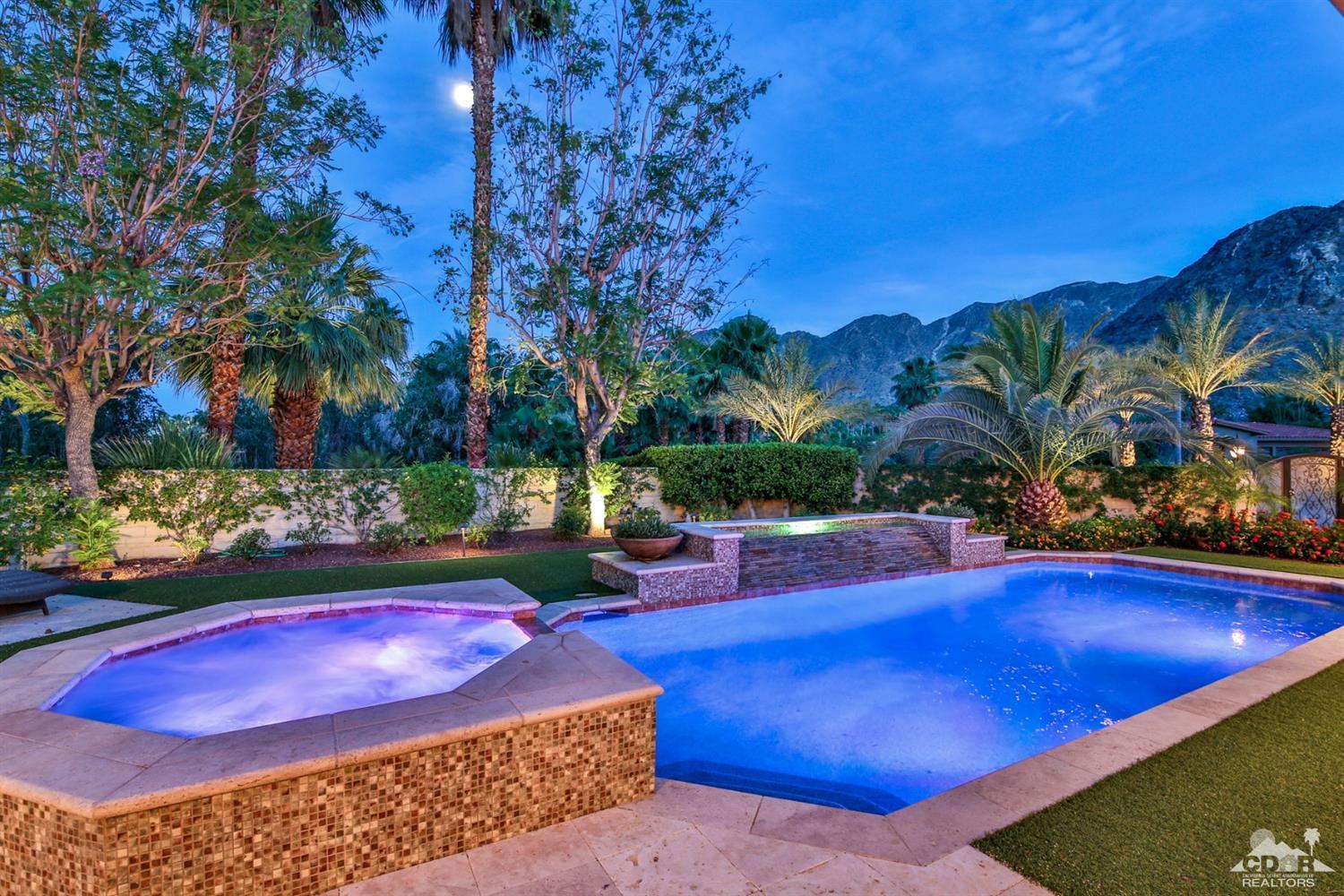 70689 Boothill Road Rancho Mirage, CA 92270 - Photo 38 of 45 a view of a swimming pool with lawn chairs under an umbrella