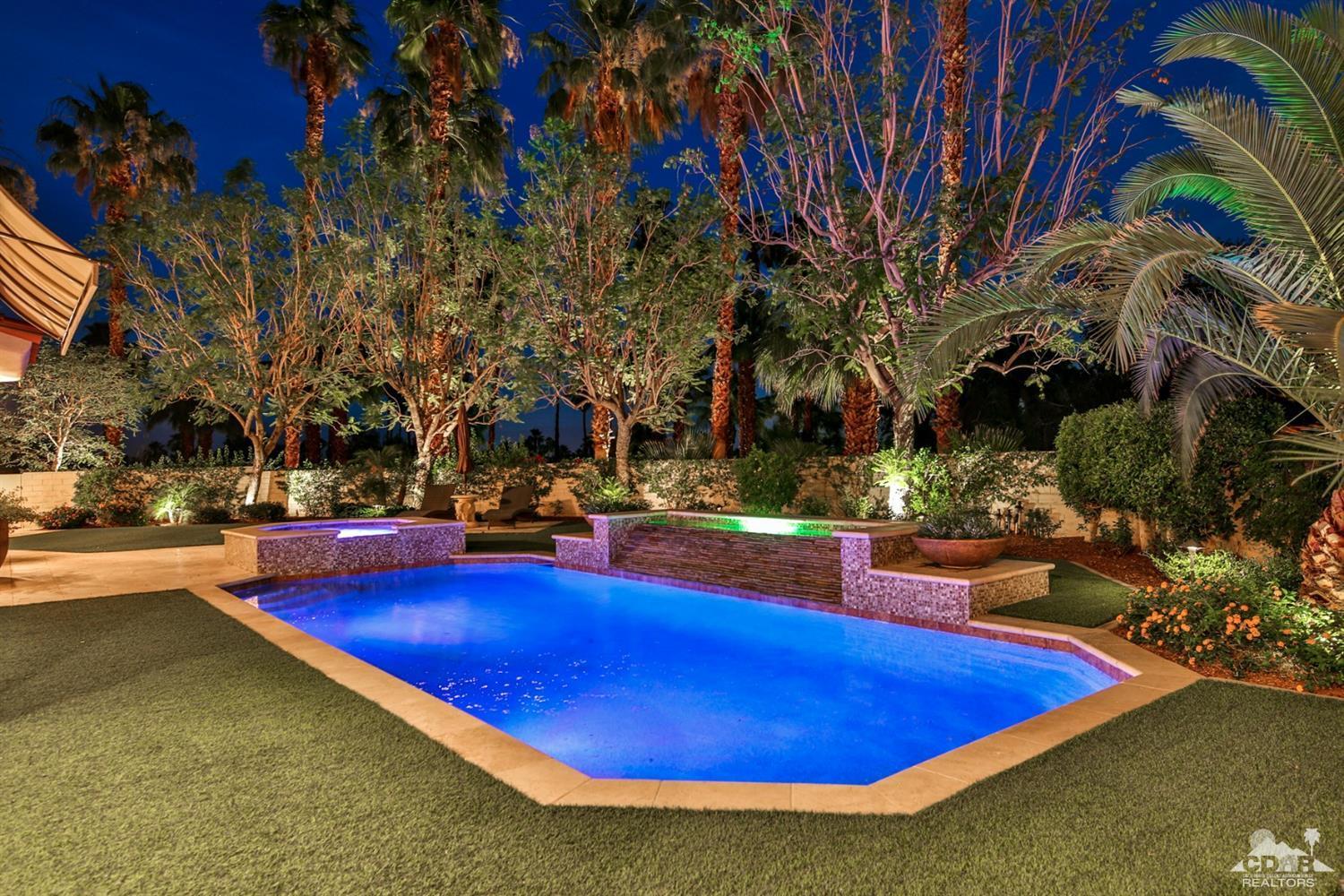 70689 Boothill Road Rancho Mirage, CA 92270 - Photo 39 of 45 a view of a swimming pool with lawn chairs under an umbrella