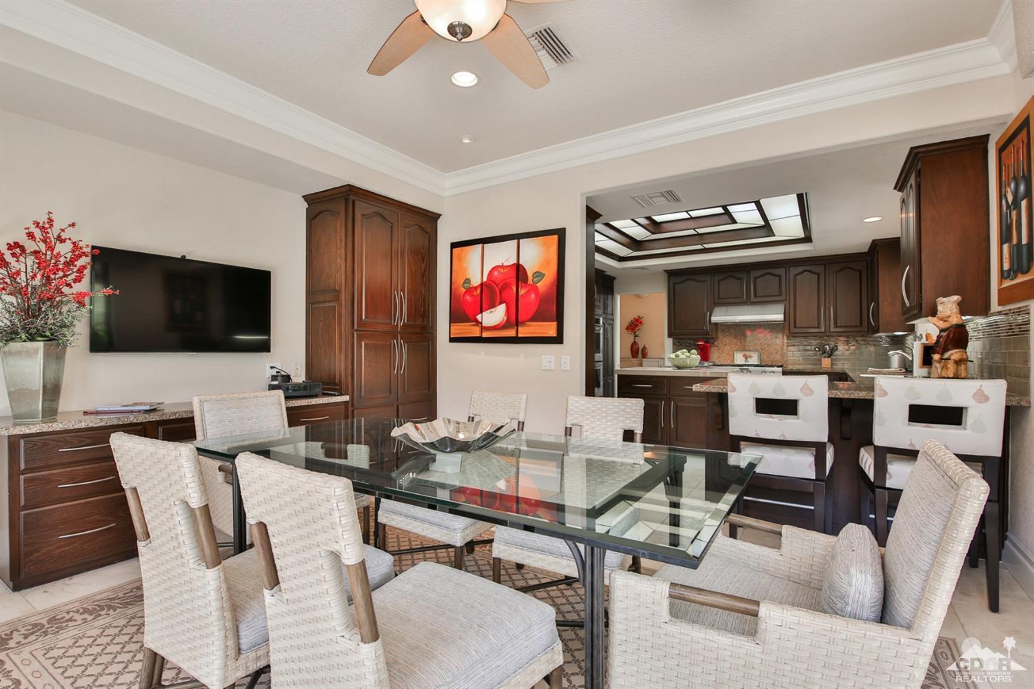 70689 Boothill Road Rancho Mirage, CA 92270 - Photo 5 of 45 a living room with furniture a flat screen tv and kitchen view