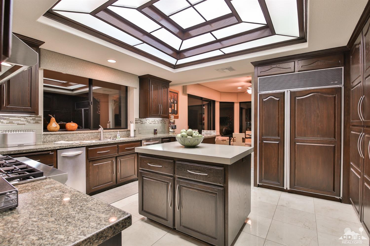 70689 Boothill Road Rancho Mirage, CA 92270 - Photo 6 of 45 a kitchen with stainless steel appliances granite countertop a sink a stove and a refrigerator