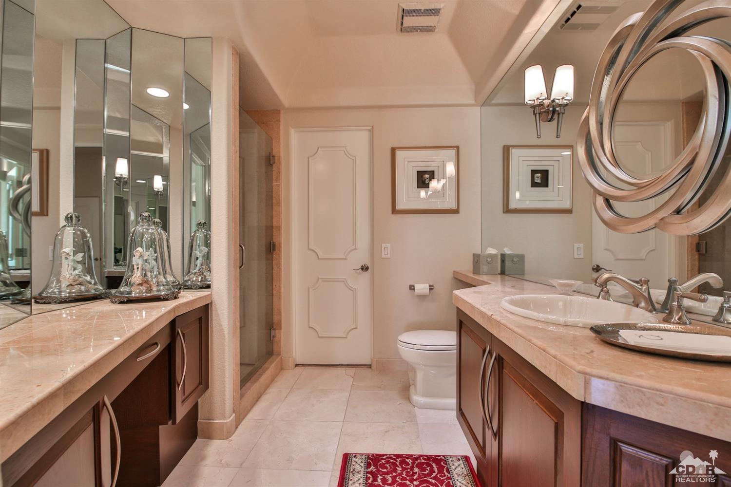 70689 Boothill Road Rancho Mirage, CA 92270 - Photo 10 of 45 a spacious bathroom with a sink a toilet and a mirror