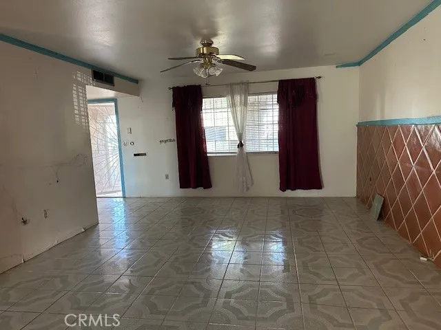 a view of a kitchen with wooden cabinets