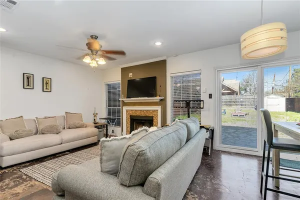a living room with furniture a fireplace and a flat screen tv